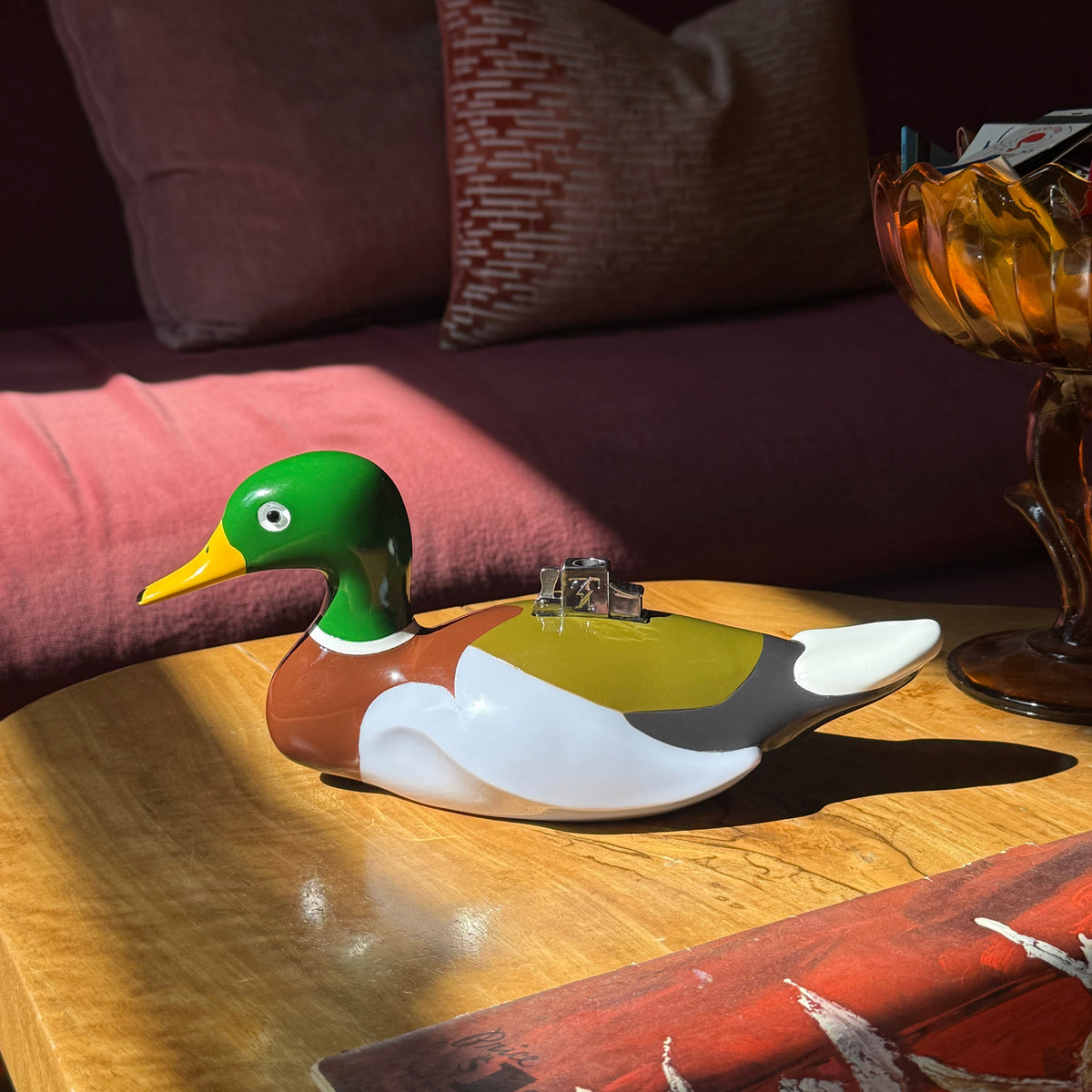Edie Parker Mallard Tabletop Lighter on a coffee table